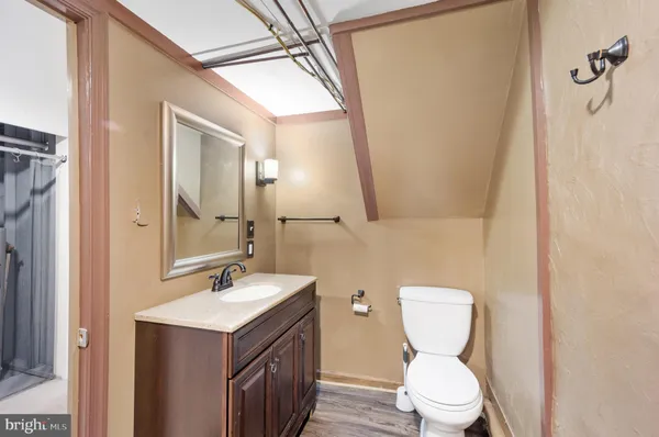 a bathroom with a toilet sink and mirror
