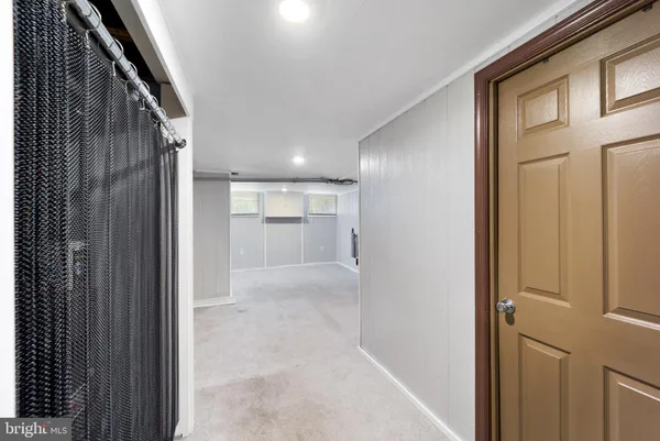 a view of a hallway with wooden shelves