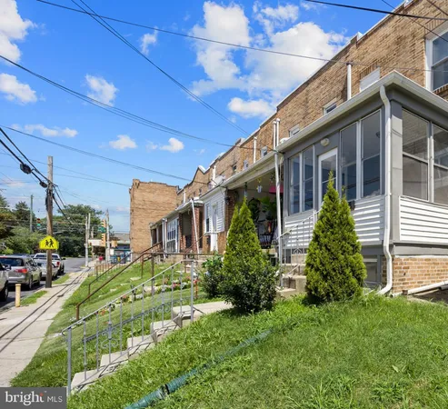 a view of a house with many windows and plants