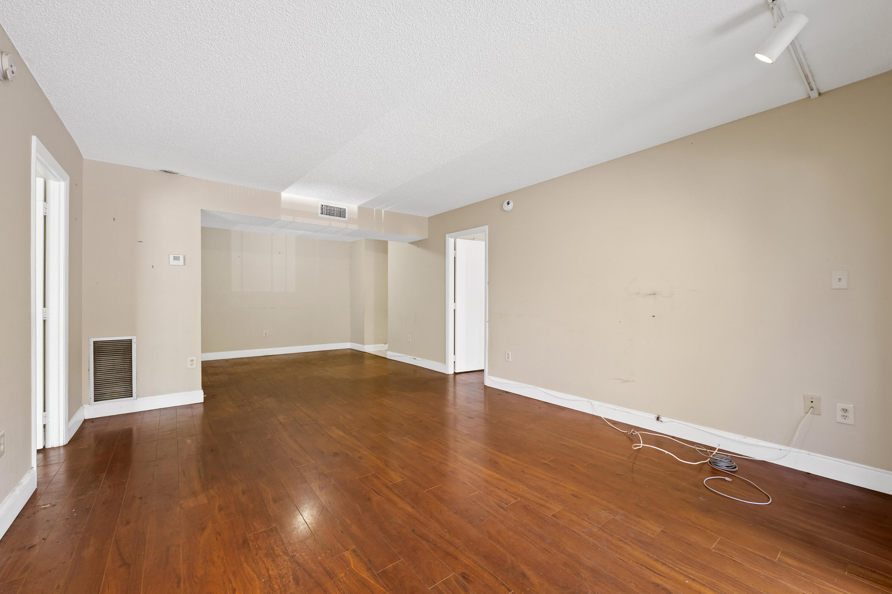 4156 Inverrary Drive, Unit 210 Lauderhill, FL 33319 - Photo 20 of 27 a view of an empty room with wooden floor