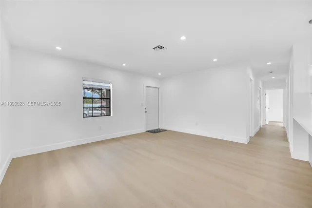 an empty room with a empty space and windows