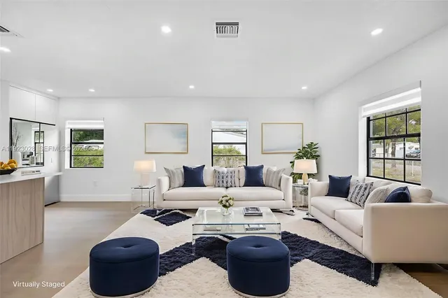 a living room with furniture a lamp and a window