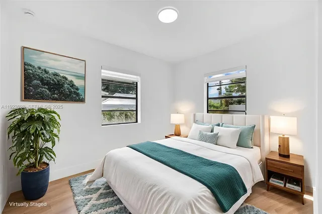 a bedroom with a bed and a painting on the wall