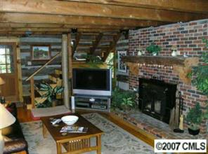 3492 Rhyne Forest Road Iron Station, NC 28080 - Photo 5 of 8 a living room with furniture a fireplace and a flat screen tv