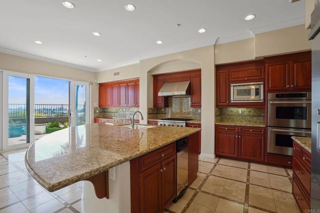 a kitchen with granite countertop sink and granite counter top