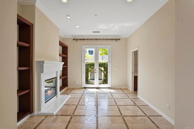 a view of an empty room with a window and fireplace