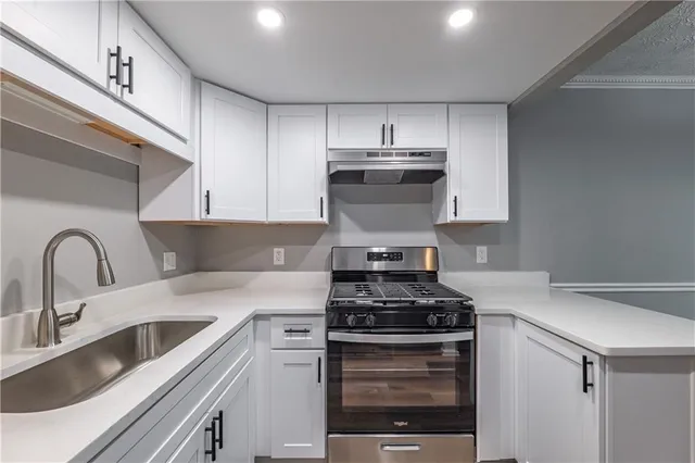 a kitchen with stainless steel appliances a refrigerator stove and sink