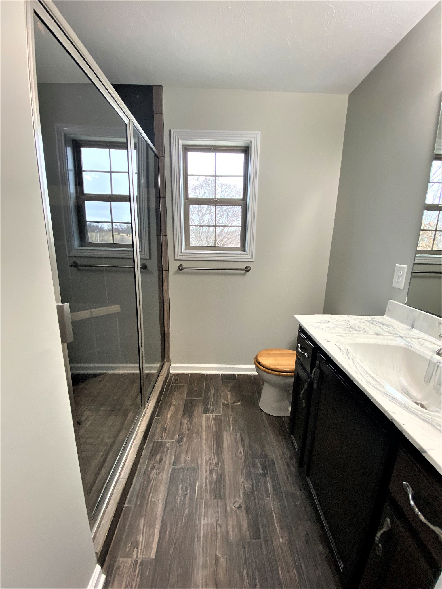 4200 Station Road Cunningham, TN 37052 - Photo 13 of 37 a bathroom with a sink a toilet a window and a shower