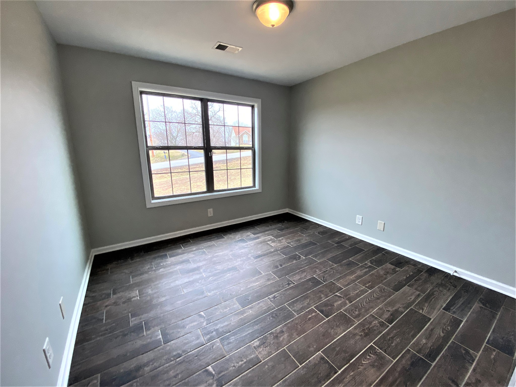 4200 Station Road Cunningham, TN 37052 - Photo 16 of 37 an empty room with wooden floor and windows