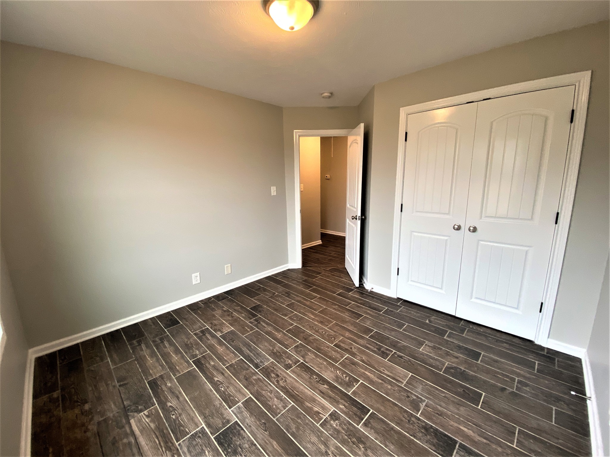 4200 Station Road Cunningham, TN 37052 - Photo 20 of 37 a view of an empty room with wooden floor and closet