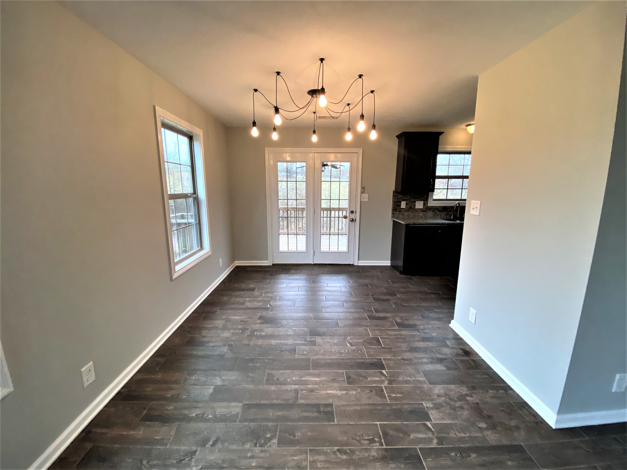 4200 Station Road Cunningham, TN 37052 - Photo 6 of 37 an empty room with wooden floor and windows