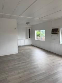 681 South Market Road Earlimart, CA 93219 - Photo 2 of 13 an empty room with wooden floor and windows