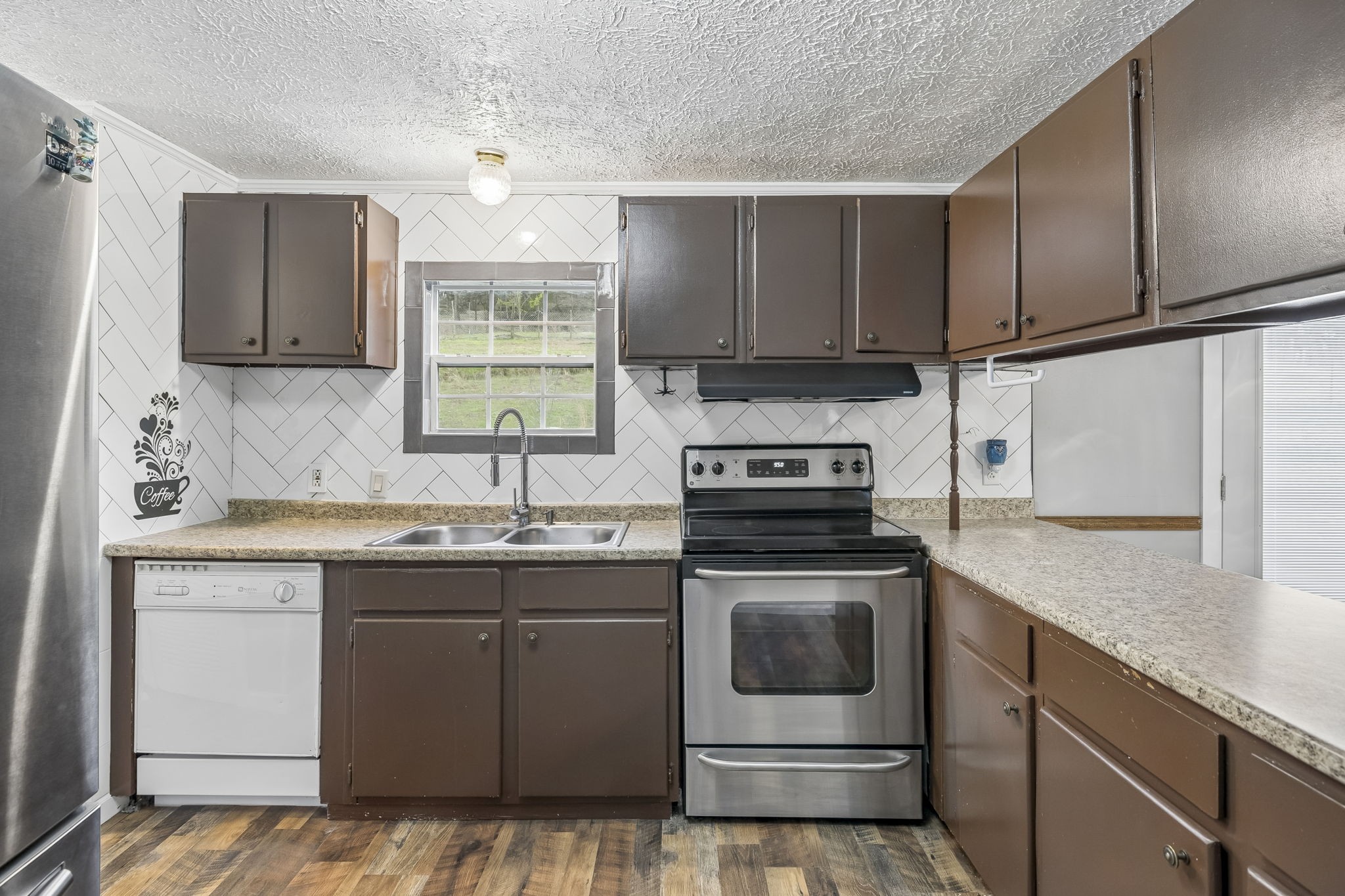 47 Riddleton Circle Riddleton, TN 37151 - Photo 11 of 46 a kitchen with a sink stove and cabinets