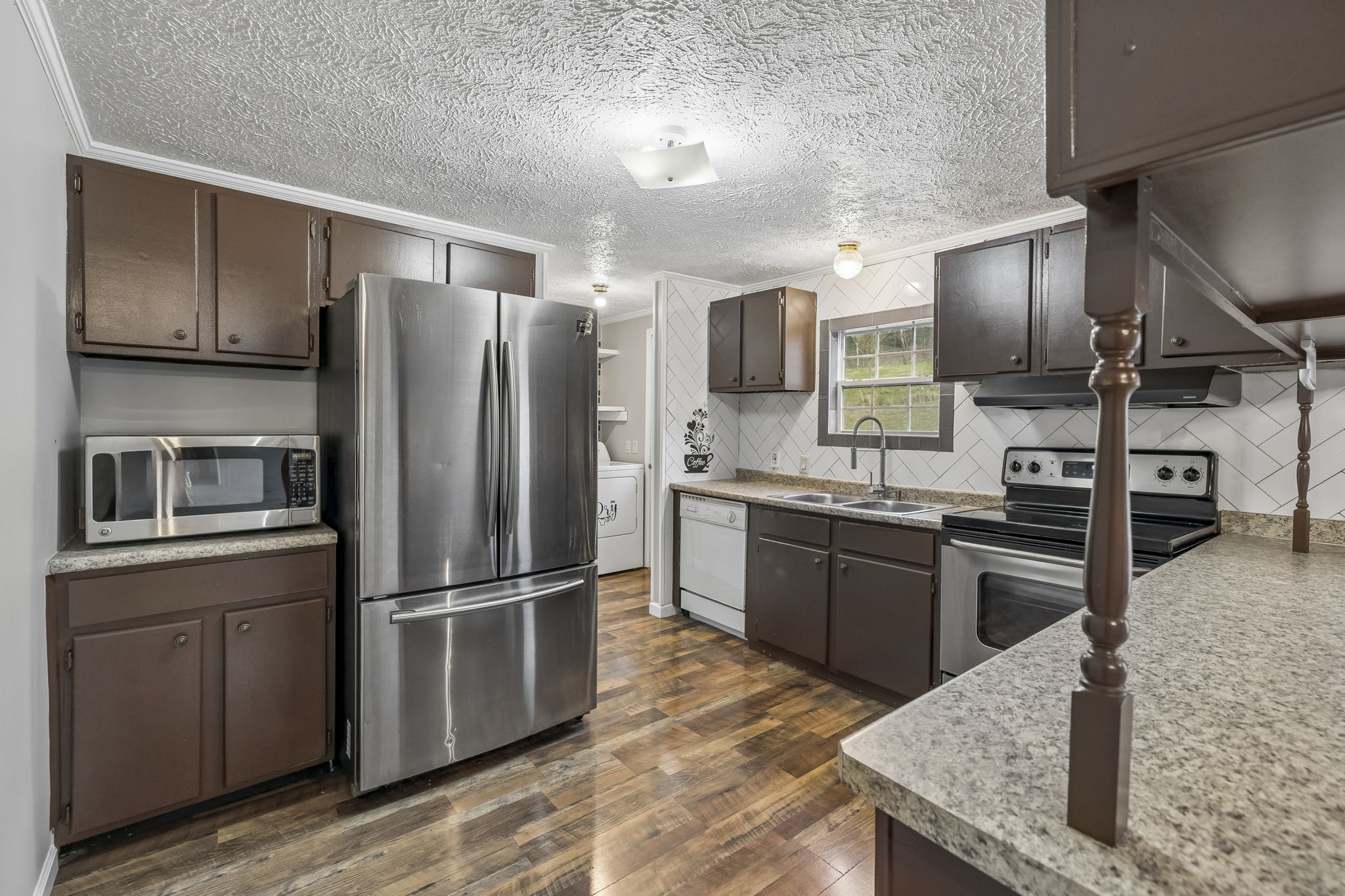 47 Riddleton Circle Riddleton, TN 37151 - Photo 10 of 46 a kitchen with stainless steel appliances granite countertop a refrigerator microwave and stove