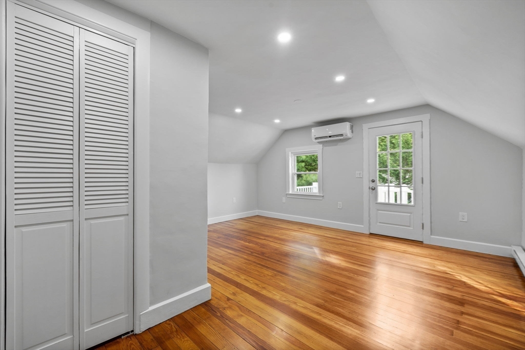 37 Fountain Road, Unit 2 Arlington, MA 02476 - Photo 14 of 25 an empty room with wooden floor and windows