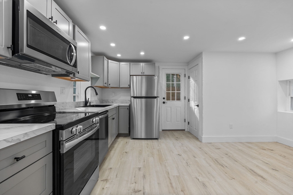 37 Fountain Road, Unit 2 Arlington, MA 02476 - Photo 19 of 25 a kitchen with stainless steel appliances granite countertop a refrigerator a stove top oven a sink and dishwasher