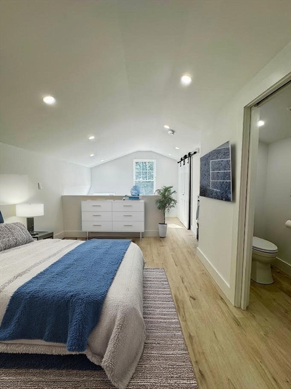 37 Fountain Road, Unit 2 Arlington, MA 02476 - Photo 23 of 25 a spacious bedroom with a bed and a large mirror