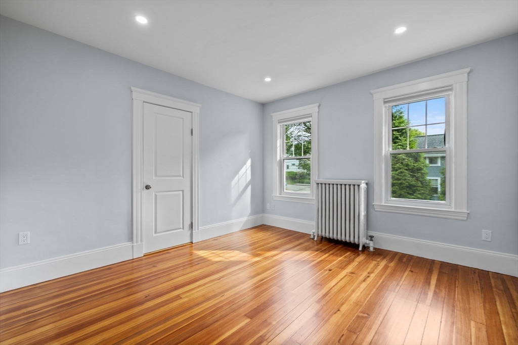 37 Fountain Road, Unit 2 Arlington, MA 02476 - Photo 9 of 25 an empty room with wooden floor and windows