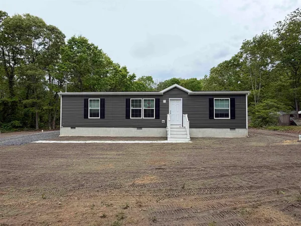 a front view of house with yard and trees
