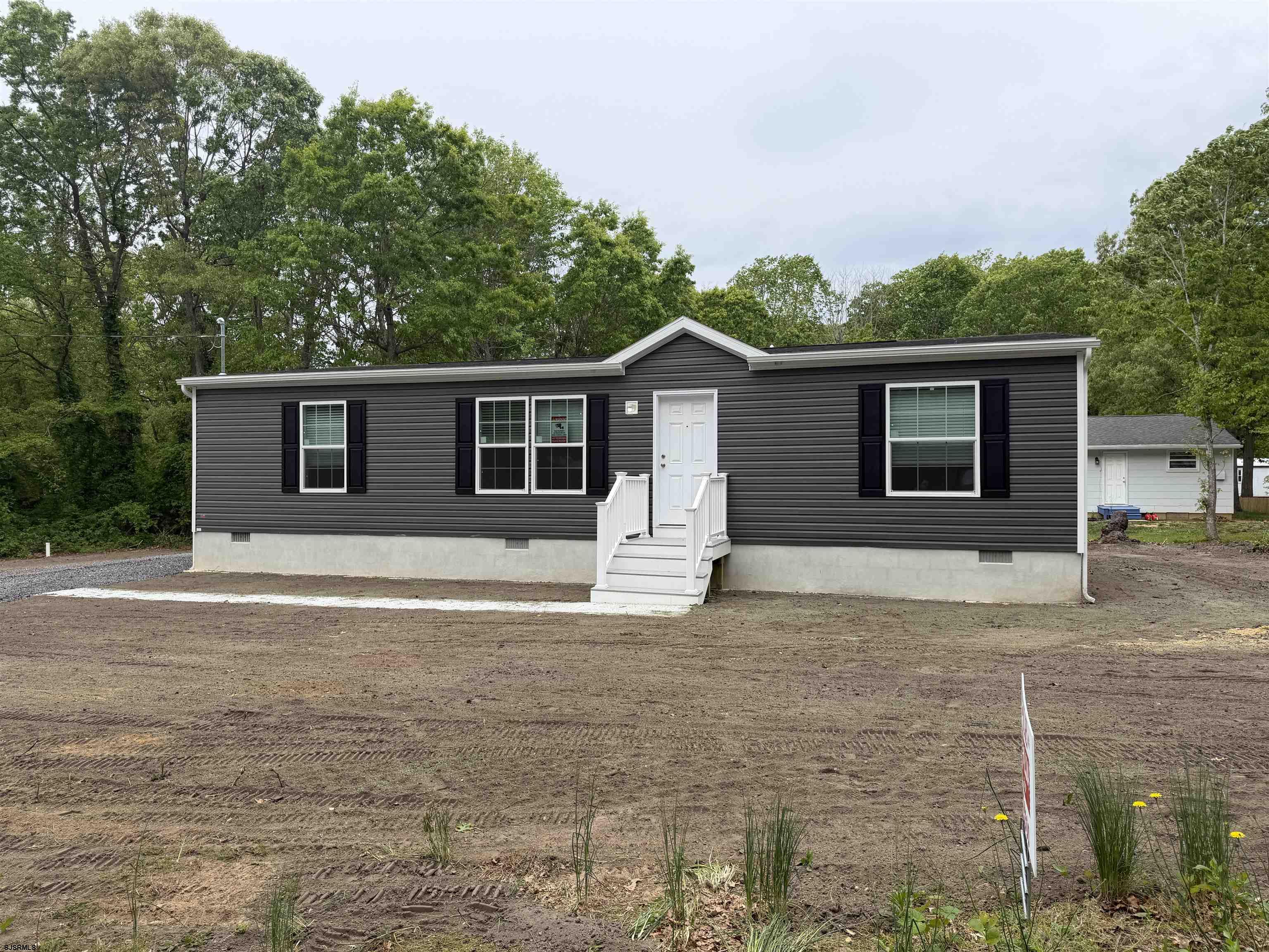 433 Poplar Road Laurel Lake, NJ 08332 - Photo 4 of 12 a front view of a house with a yard