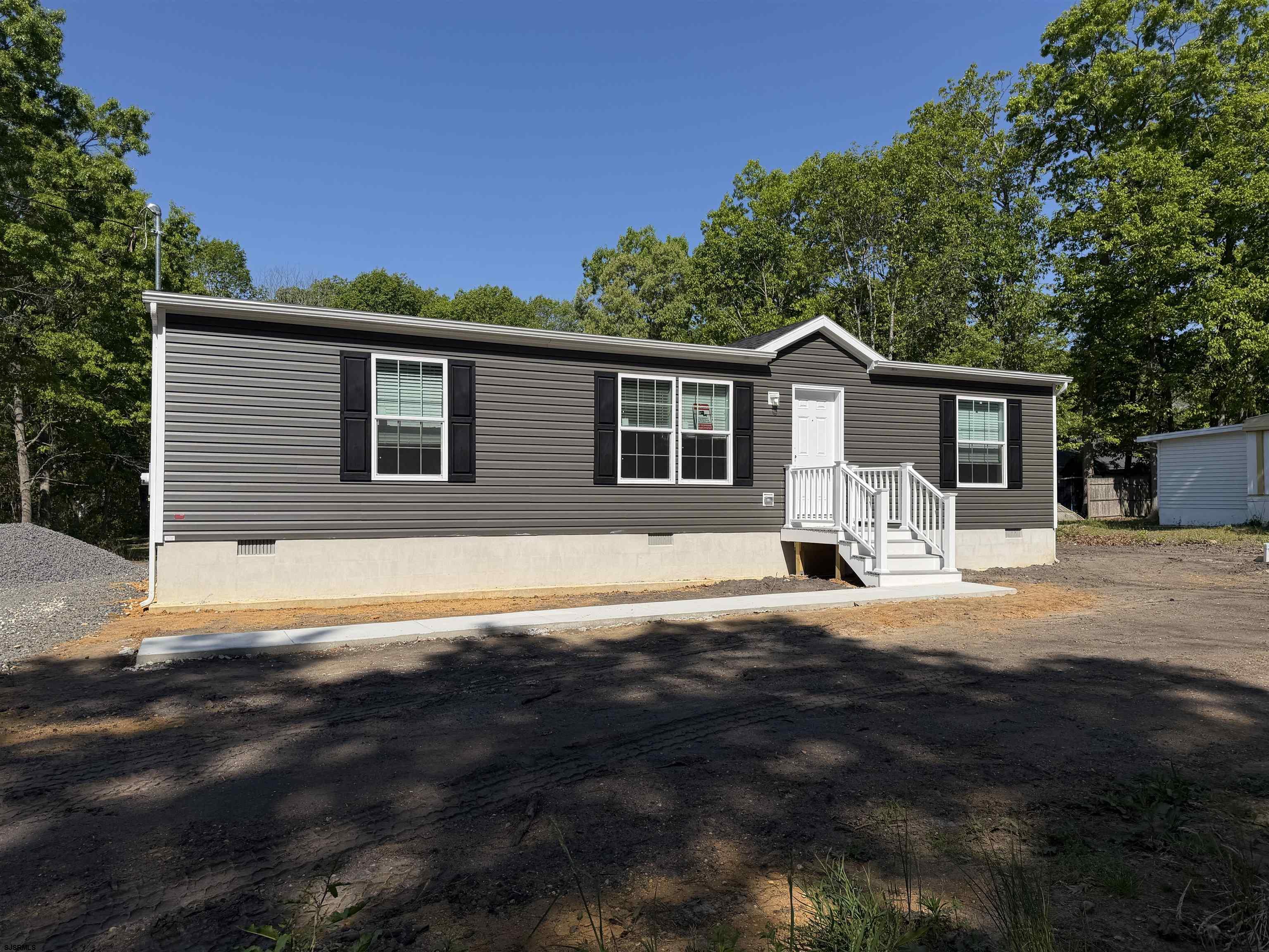 433 Poplar Road Laurel Lake, NJ 08332 - Photo 5 of 12 a front view of a house with yard patio and green space