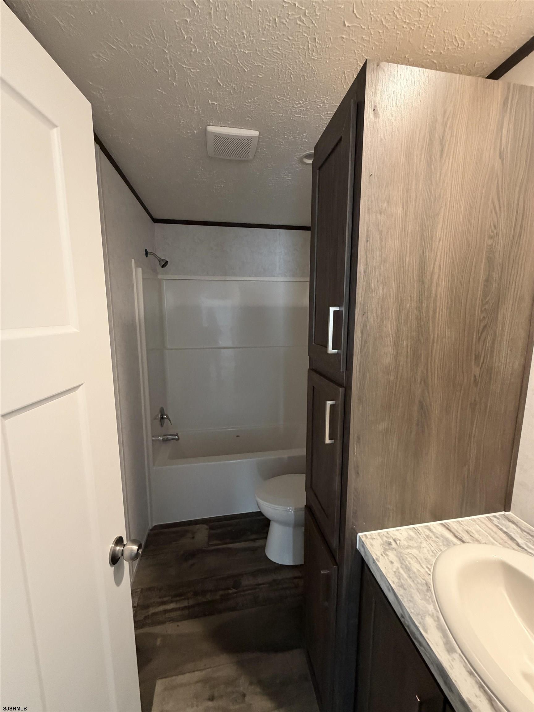 433 Poplar Road Laurel Lake, NJ 08332 - Photo 8 of 12 a bathroom with a granite countertop sink and a toilet