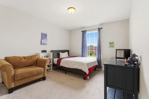 a bedroom with bed and a couch
