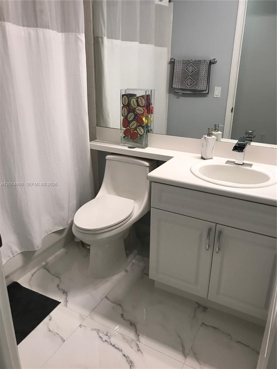 16654 Southwest 103rd Lane Miami, FL 33196 - Photo 12 of 20 a bathroom with a sink toilet and mirror