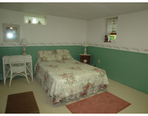 112 Knower Road Westminster, MA 01473 - Photo 7 of 10 a bed sitting in a bedroom next to a window
