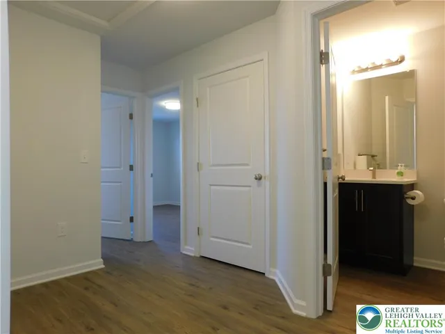 a view of hallway with wooden floor