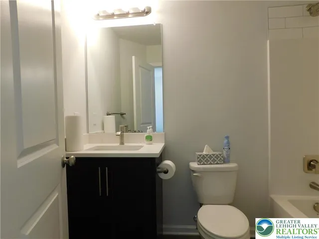 a bathroom with a sink toilet and mirror