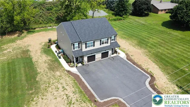 a aerial view of a house with a yard