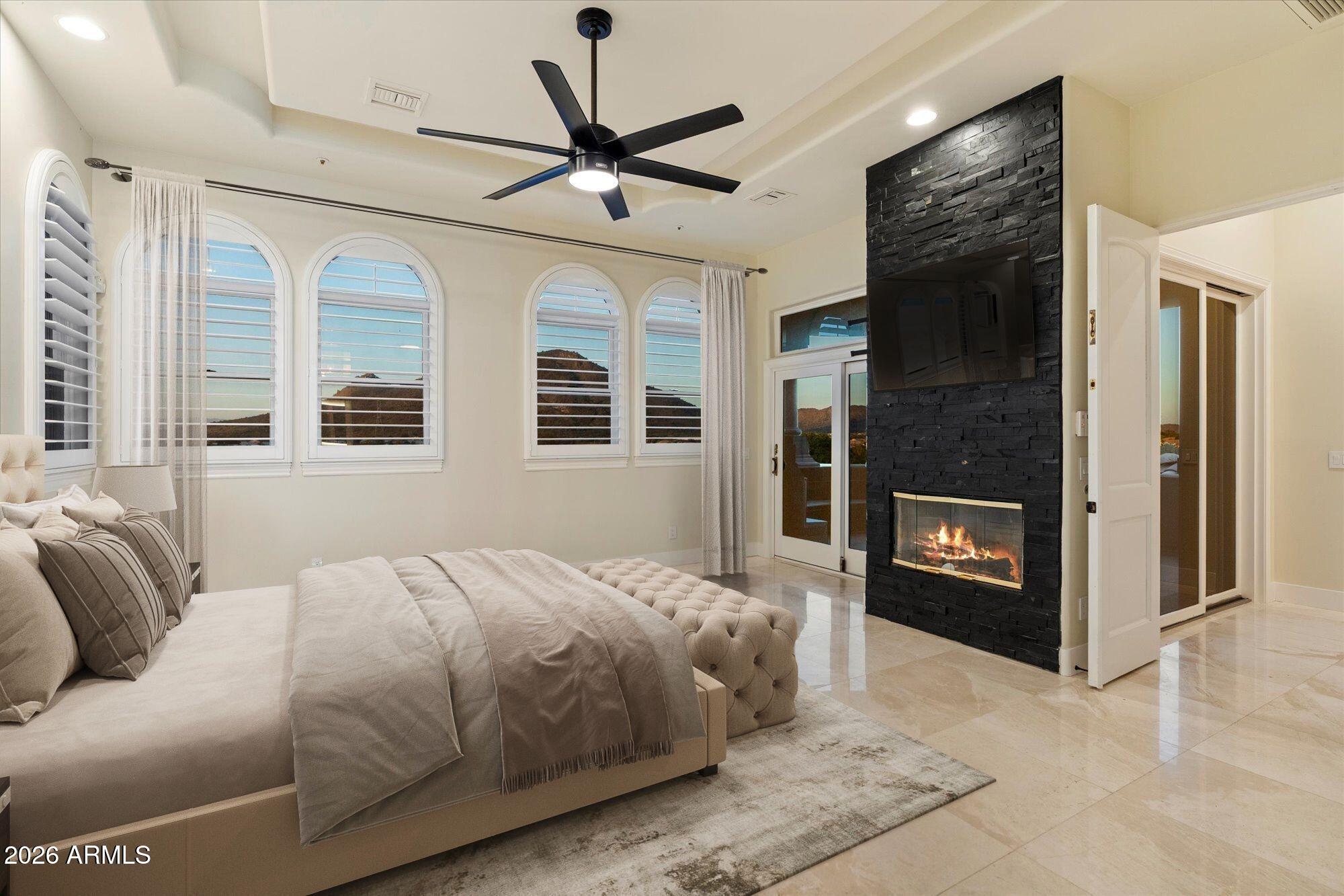 6123 West Alameda Road Glendale, AZ 85310 - Photo 25 of 39 a bedroom with a large bed and a tv