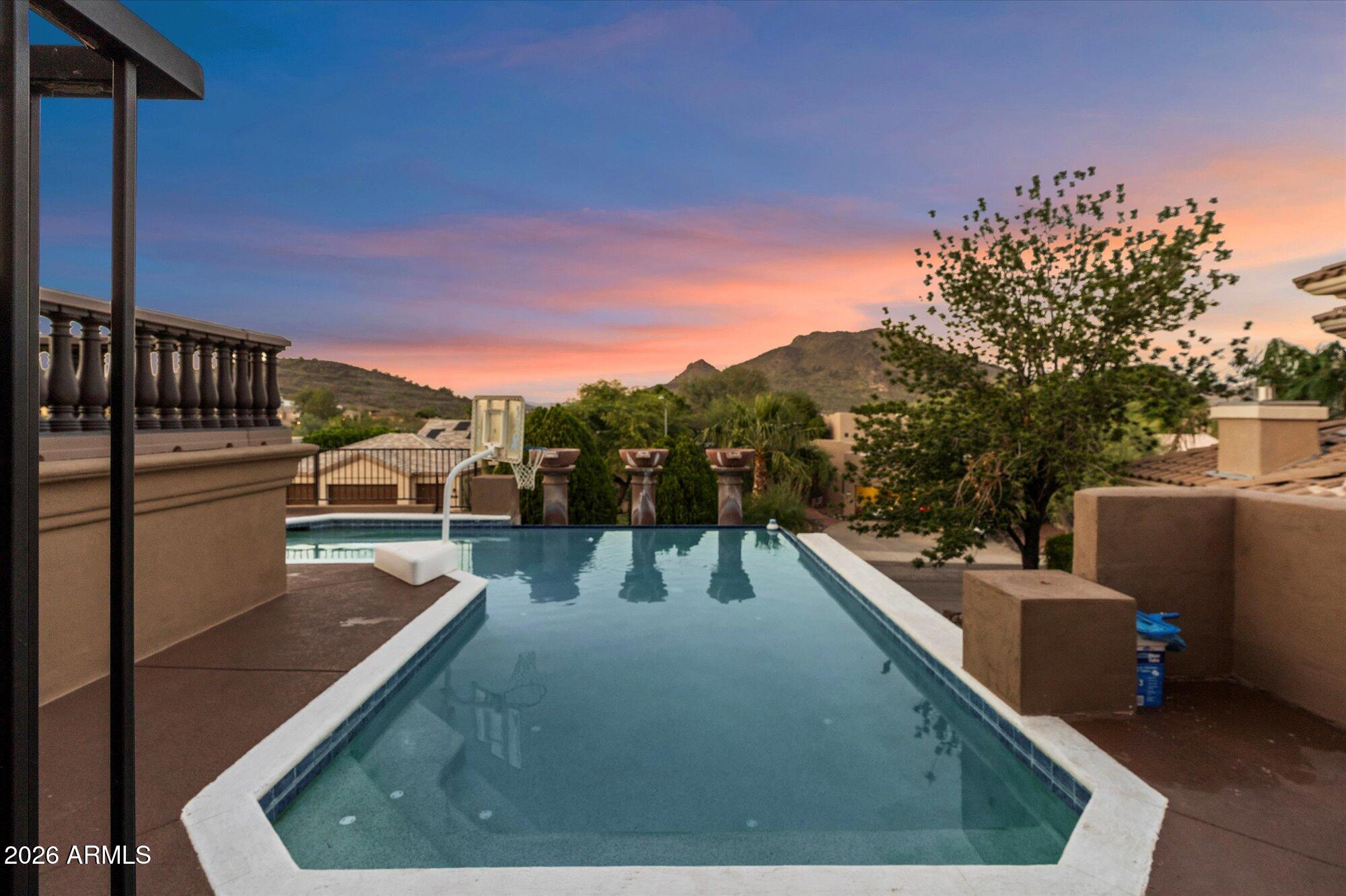 6123 West Alameda Road Glendale, AZ 85310 - Photo 6 of 39 a view of a swimming pool with a lounge chair
