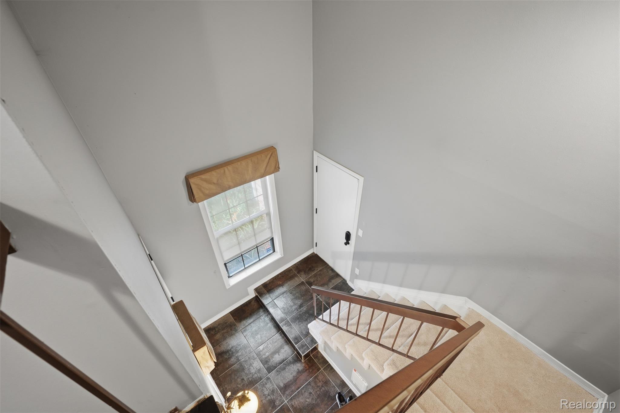 29726 Pine Ridge Circle Farmington, MI 48331 - Photo 6 of 40 Staircase featuring new carpeted treads and wood handrails.