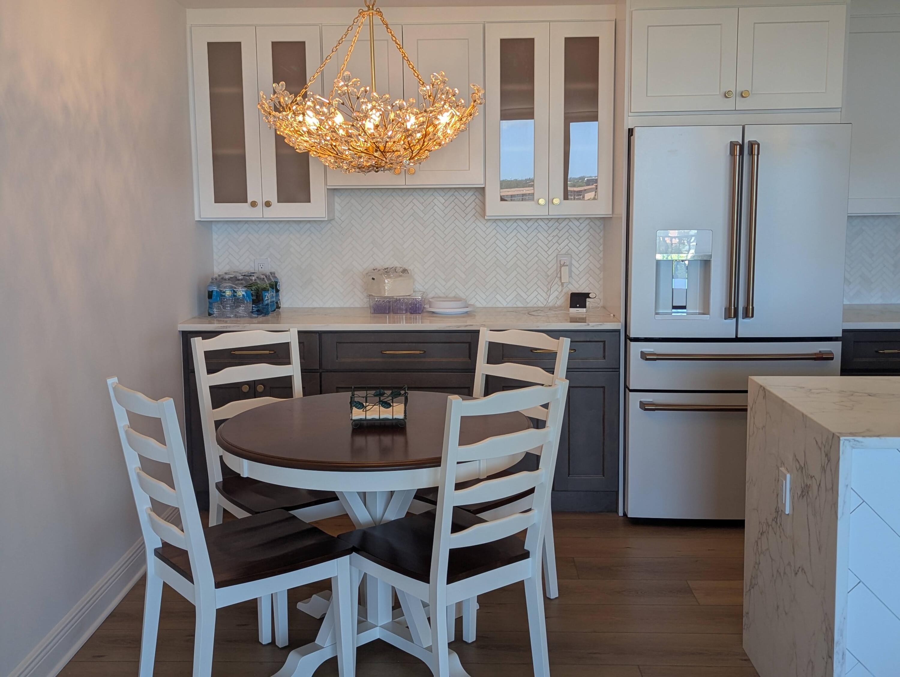 2121 North Ocean Boulevard, Unit 1006E Boca Raton, FL 33431 - Photo 11 of 64 a kitchen with a dining table and chairs