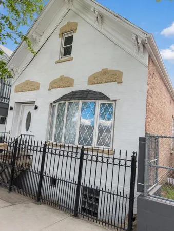 a view of a brick house with a small yard
