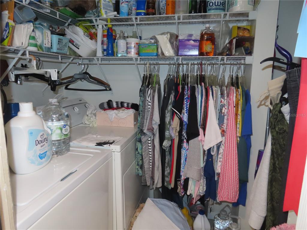 225 Country Club Drive, Unit C225 Largo, FL 33771 - Photo 14 of 26 a view of walk in closet with clothes and shoes