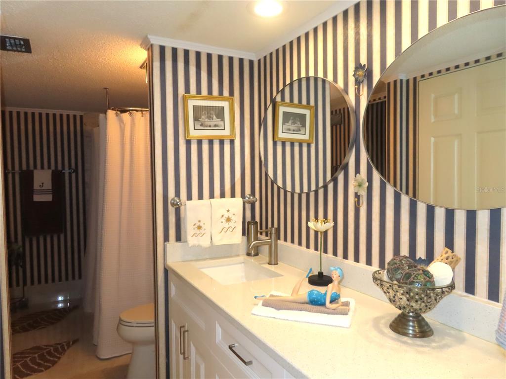 225 Country Club Drive, Unit C225 Largo, FL 33771 - Photo 15 of 26 a bathroom with a sink toilet and shower