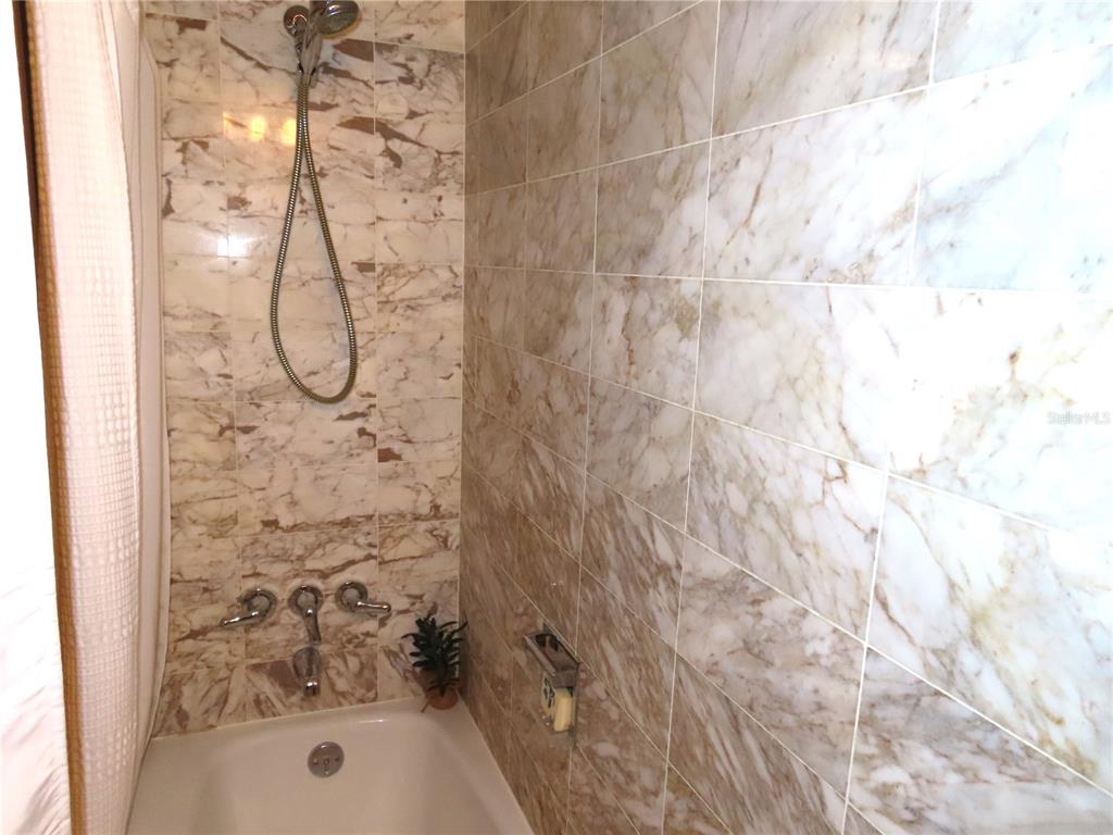 225 Country Club Drive, Unit C225 Largo, FL 33771 - Photo 19 of 26 a bathroom with a shower
