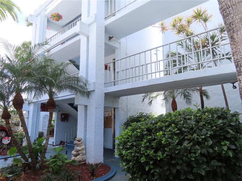 225 Country Club Drive, Unit C225 Largo, FL 33771 - Photo 2 of 26 a view of a house with a flower plants