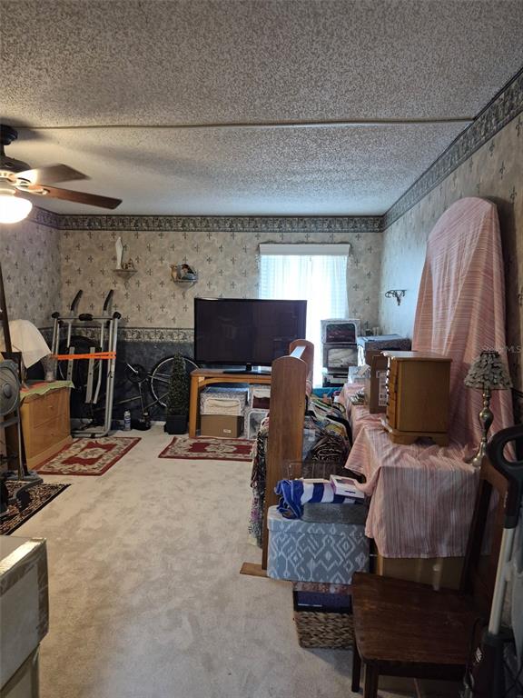 225 Country Club Drive, Unit C225 Largo, FL 33771 - Photo 22 of 26 a room with furniture a flat screen tv and a fireplace