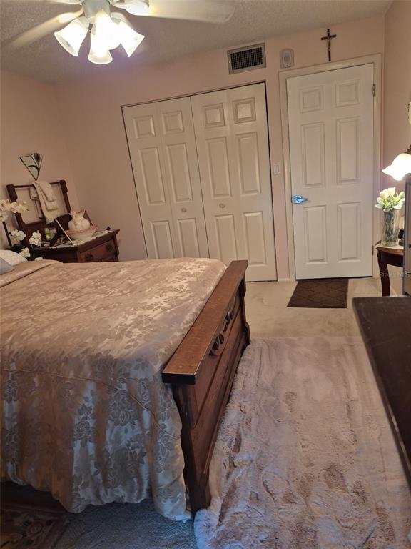 225 Country Club Drive, Unit C225 Largo, FL 33771 - Photo 25 of 26 a room with a bed and a chandelier