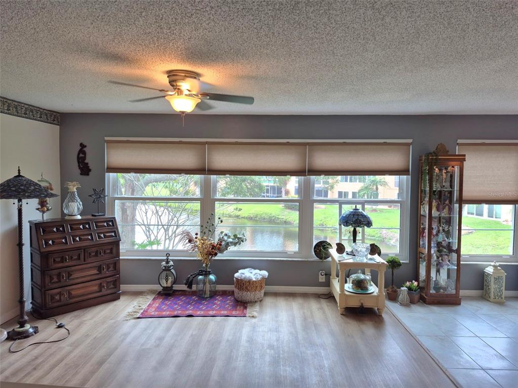 225 Country Club Drive, Unit C225 Largo, FL 33771 - Photo 4 of 26 a living room with furniture and a large window