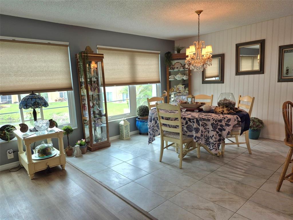 225 Country Club Drive, Unit C225 Largo, FL 33771 - Photo 5 of 26 a living room with furniture and a chandelier