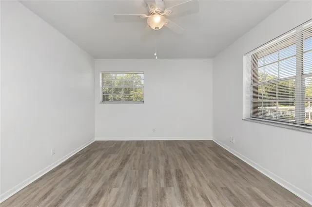 wooden floor in an empty room with a window