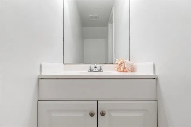 a bathroom with a sink and vanity