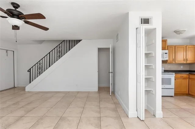 a view of hallway with stairs and wooden floor