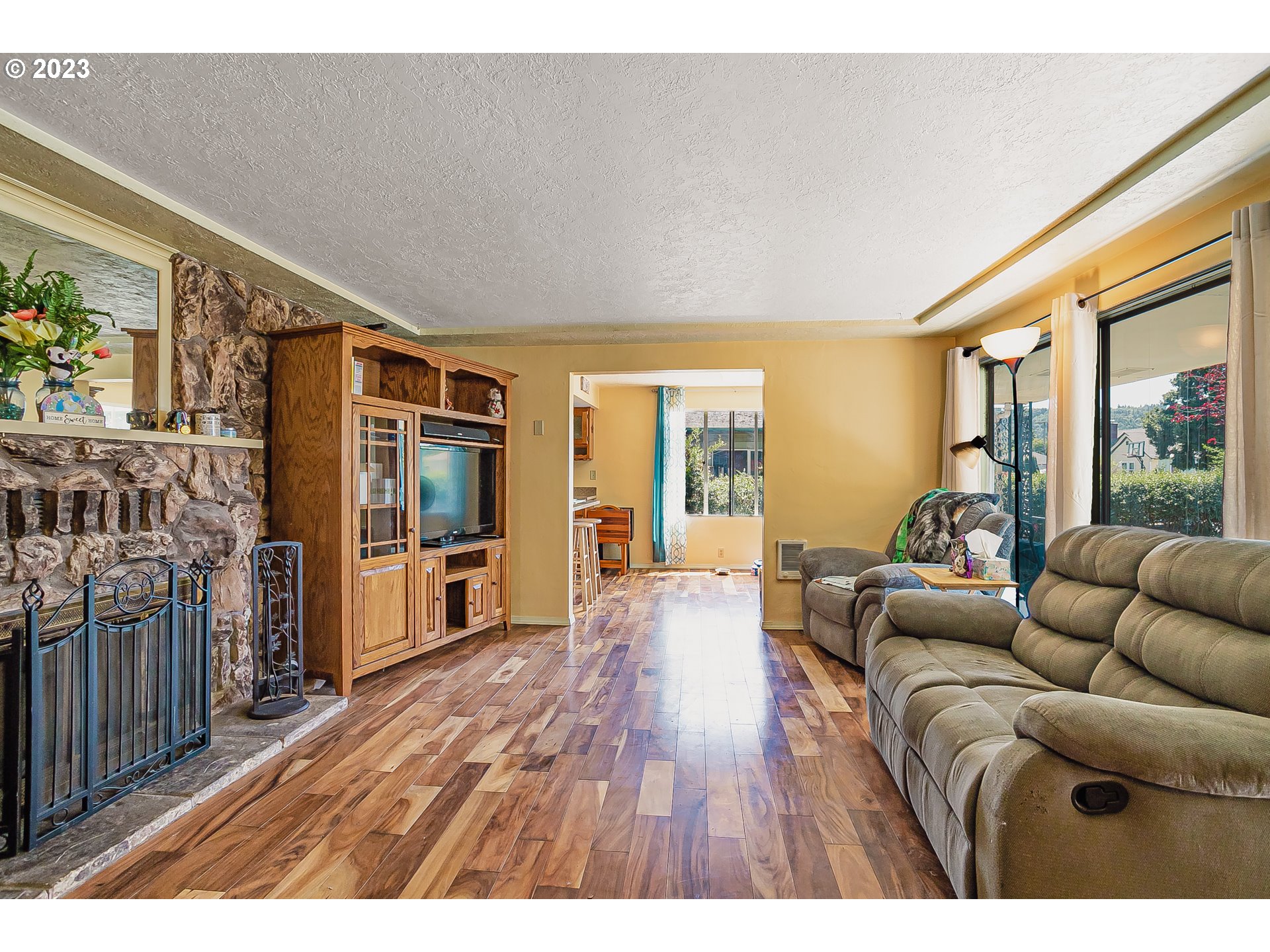 465 North 24th Street Springfield, OR 97477 - Photo 6 of 30 a living room with furniture floor to ceiling window and wooden floor