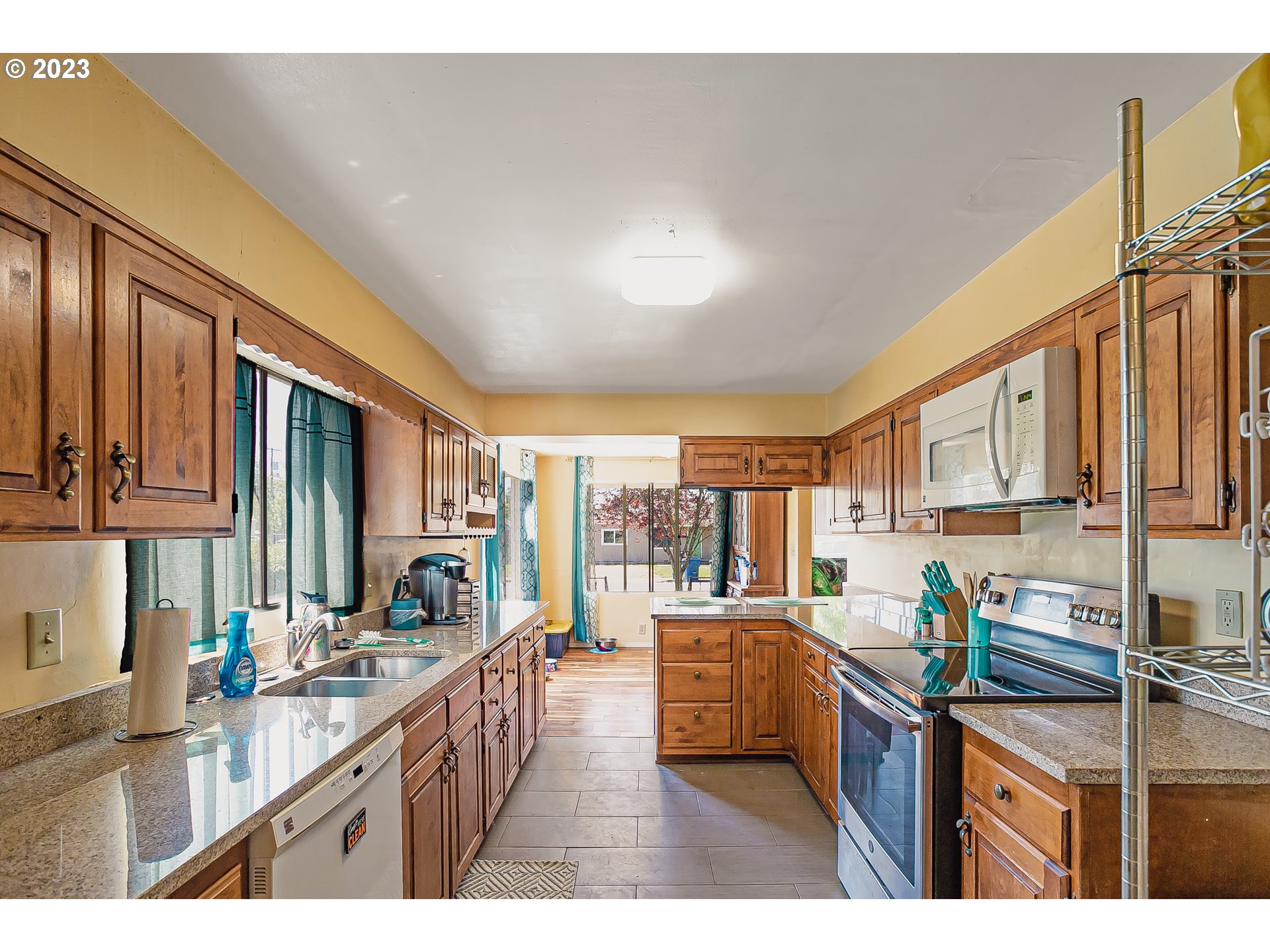 465 North 24th Street Springfield, OR 97477 - Photo 8 of 30 a open kitchen with stainless steel appliances kitchen island granite countertop a sink and cabinets